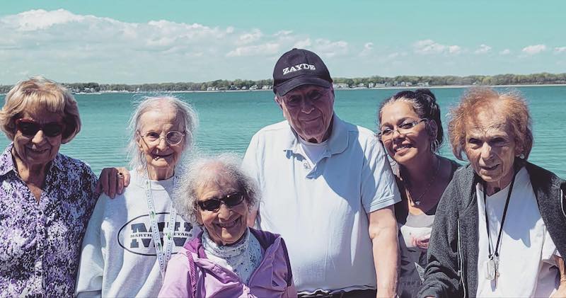 Five Tamarisk Senior Living residents and one staff member visit a beach in Rhode Island