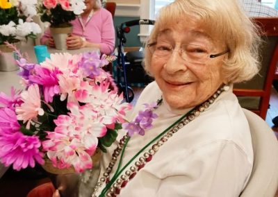 A resident holding pretty flowers